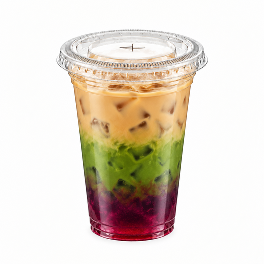 A clear plastic cup with a clear lid containing a layered iced drink with four distinct colors: a dark red/purple base, a green middle layer, a tan/beige top layer, and a light beige iced coffee layer on top. The cup is centered on a solid white background.