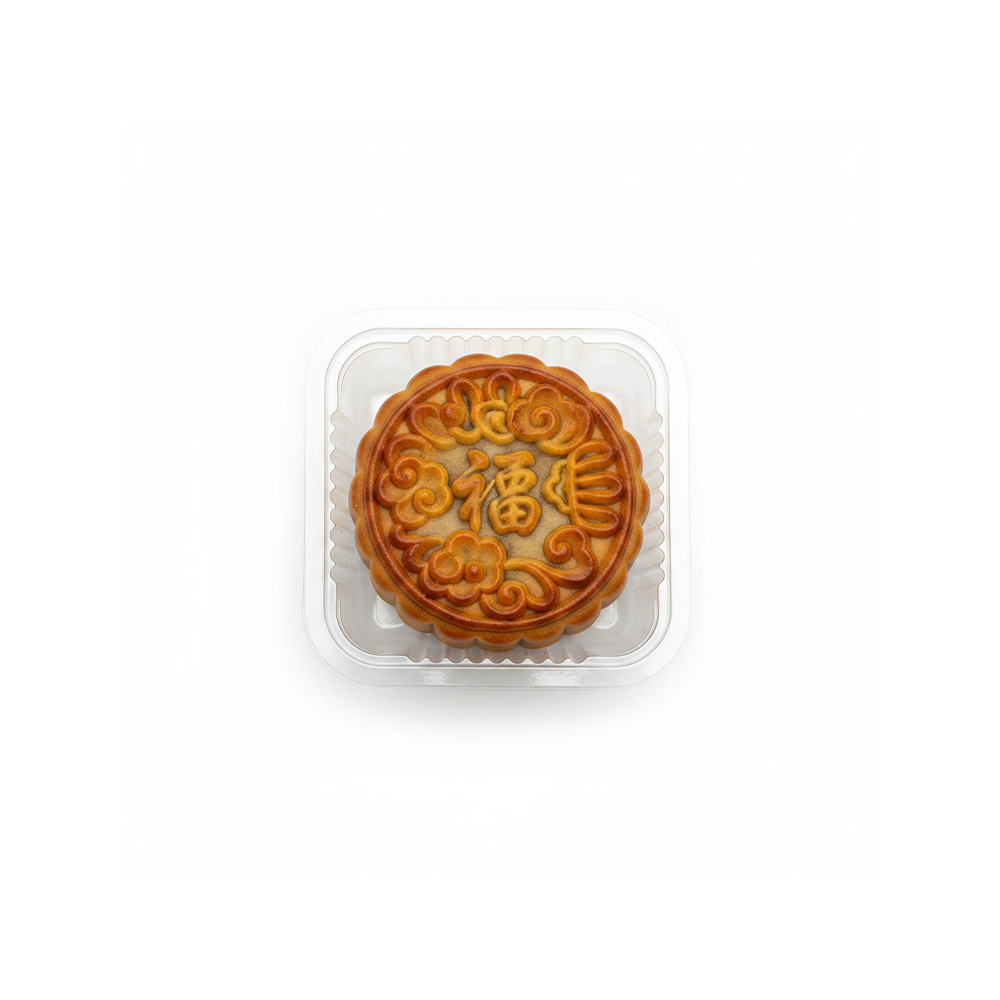 A single golden-brown mooncake in a clear plastic clamshell container, centered on a plain white background.