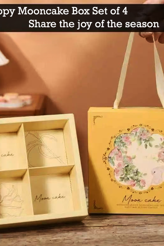 A yellow mooncake gift box set with a floral illustration and the words 'Moon cake' on the front, shown next to an open four-compartment inner box. A hand holds one of the cream-colored handles.